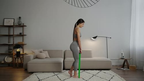 Woman Exercising with Resistance Band Indoors