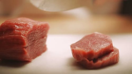 Chef Cutting Tender Raw Meat for Cooking Preparation