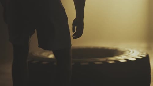 Strong man flipping tyre