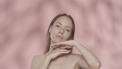 A Woman Demonstrates Her Smooth Clear Healthy Skin Woman Touches Her Face and Neck in the Studio on