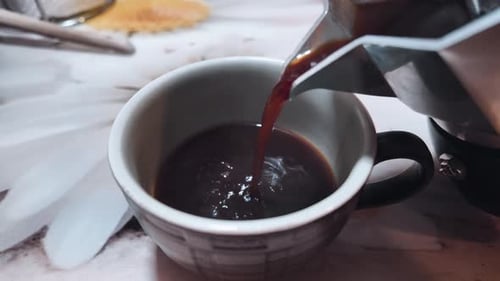 Coffee Pouring into a Cup from Coffee Pot