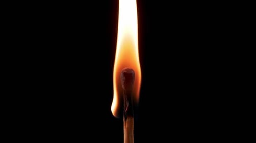 Burning Match Flame on Black Background