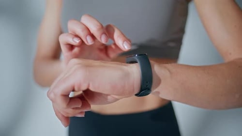 Woman Using Fitness Tracker in Activewear