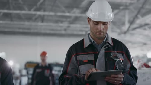 Machine Engineer Works at Machinery Manufacture. Male Person in Hardhat or Protective