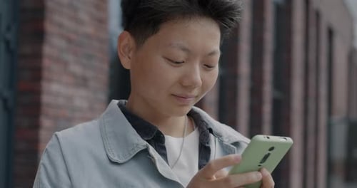 Young Adult Using Smartphone in Urban Setting