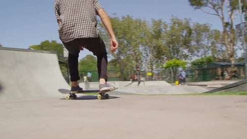 Man skateboarding in skate park on sunny day
