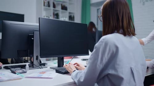 Modern Office Of Software Development Company Women Workers Typing Program Code On Computers