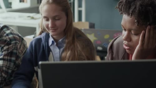 Teen Students Studying Together at School on Computer