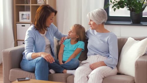 Mother, Daughter, and Grandmother Relaxing Together at Home