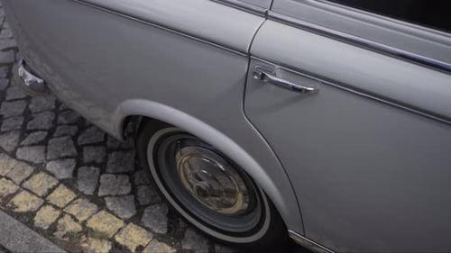 Close up of vintage car wheel and chrome trim