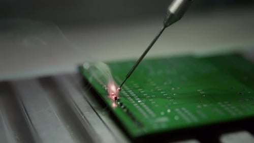 Close Up Soldering a Circuit Board