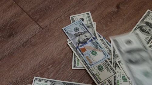 CloseUp Of Falling Hundred Dollar Bills Symbolizing Economic Stability