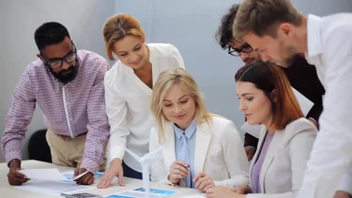 Multiethnic business team discussing green renewable energy project in office