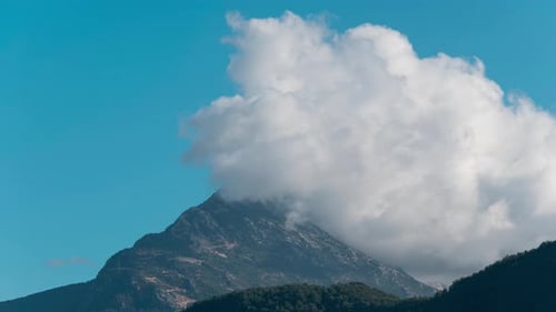 White Clouds Forming Over Mountain Peak