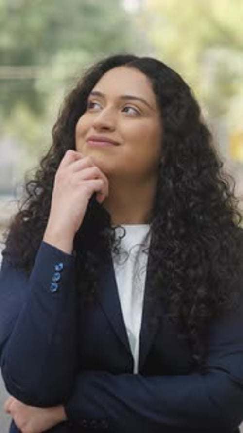 Thoughtful Woman in Business Suit Looking Upward