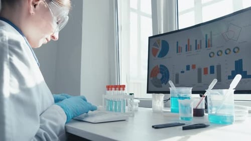 Scientist Working at Computer in Bright Laboratory