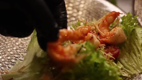 Chef prepares seafood dishes in a Japanese restaurant