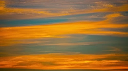 Colorful skyline close up time lapse, blue skyline and orange clouds passing by celestial sky