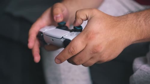 Hands Using Video Game Controller for Entertainment