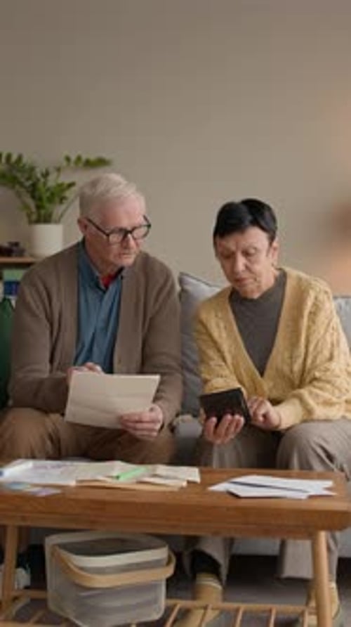 Senior Couple Reviewing Finances Together at Home