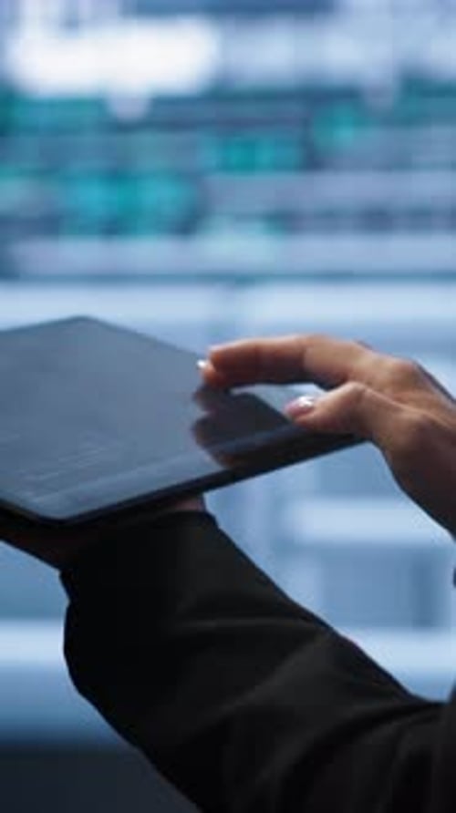 Hand Interacts with Tablet in Modern Office