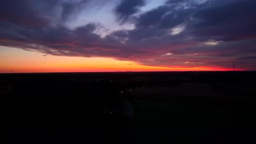 Spectacular colored sky in pink, purple and orange colors at sunrise over city suburb in USA.