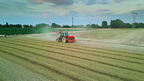 Tractor Working in a Field Surrounded by Farmlands - Aerial View 4K