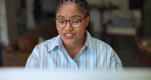 Young Woman Talking During Online Meeting at Home
