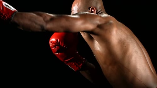 Powerful Man Boxing Punching in Red Gloves