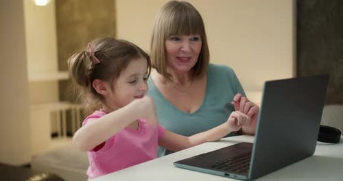 Portrait of Nice Granny and Grandchild Using Laptop Making Video Calls Waving Hi Hello