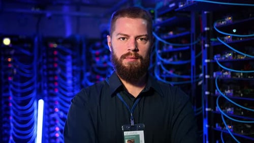 IT Professional Stands in Data Center Server Room