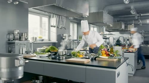 Time-Lapse Panoramic Shot of Big Restaurant Kitchen and Three Chefs Working.