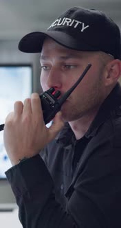 Security Guard Communicating on Walkie Talkie