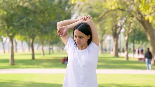 Woman Stretching Arms in Park, Fitness and Wellness
