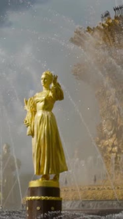 Gilded Statues on Background of Fountain Action Beautiful Golden Statues of Women Shine on