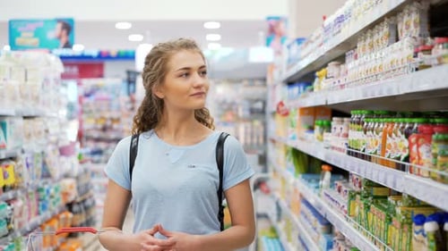 Mother Alone Look For Child'S Fruit Puree And Juices Inside Of Market Place And Think To Buy. Bea...