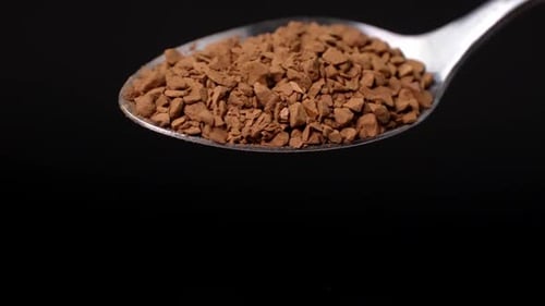 Spoonful of Instant Coffee Granules Falling