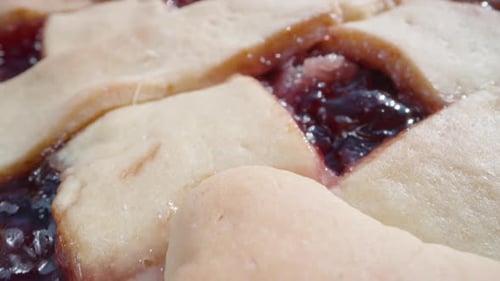pie with cherry jam, cut on the table, the jam flows down on the table. View from above. Dolly slide