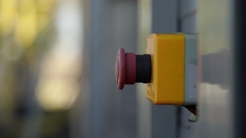 Man hand pressing red industrial button in slow motion