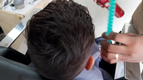 Hairdressing services. man cuts hair at a hairdresser-stylist in a barbershop. scissors comb close-u