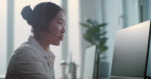 Portrait of Asian Technical Customer Support Specialist Talking on Headset