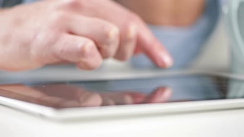4k video of a man using his digital tablet at home