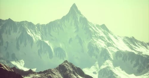 Majestic Snow Capped Mountain Peak Rising Under Bright Sky During Daylight