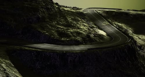 Winding Mountain Road with Dramatic Lighting During Twilight Hours