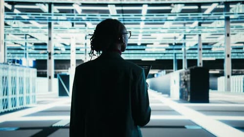 Software Developer Walks in Data Center Using Tablet and AR Technology