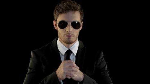 Man in Black Suit and Sunglasses Stares