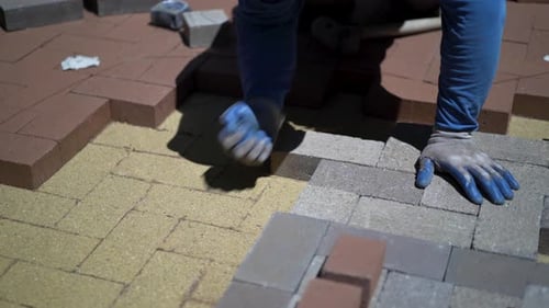Craftsman Laying Pavers for Outdoor Patio