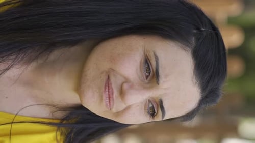 Woman Rubs Face in Discomfort and Pain