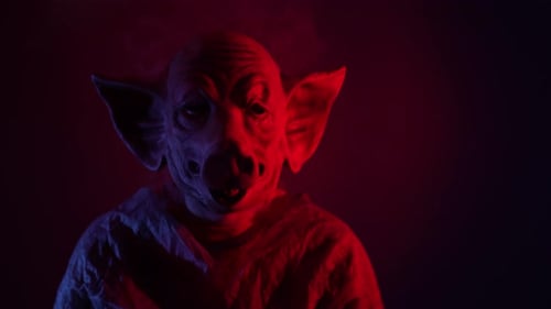 Creepy Masked Figure in Red and Blue Light
