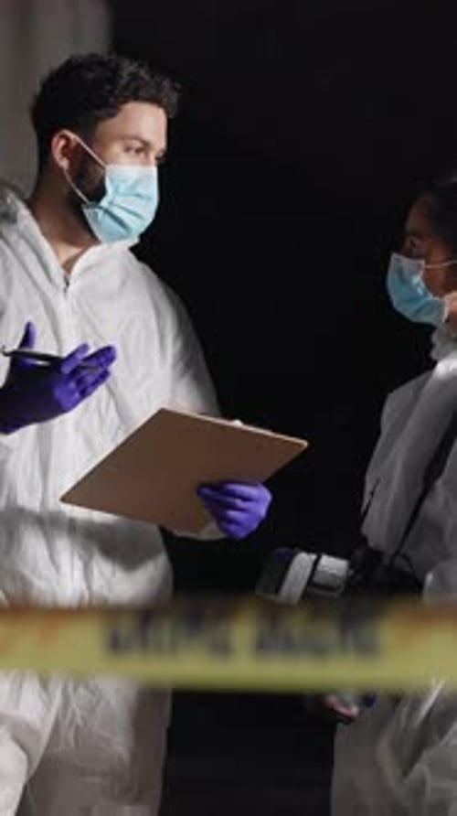 Investigators in Protective Suits at Night Crime Scene